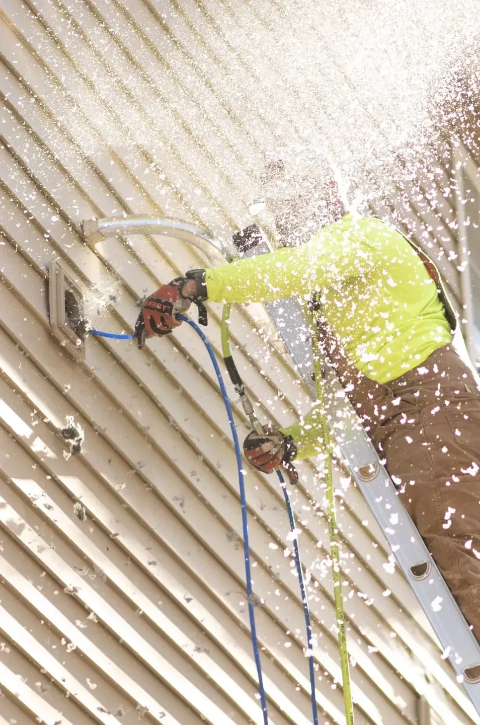 Technician cleaning commercial dryer vent to improve airflow and fire safety