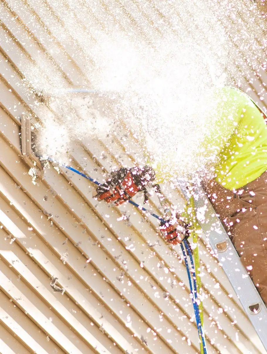 Dryer vent cleaning technician removing lint buildup